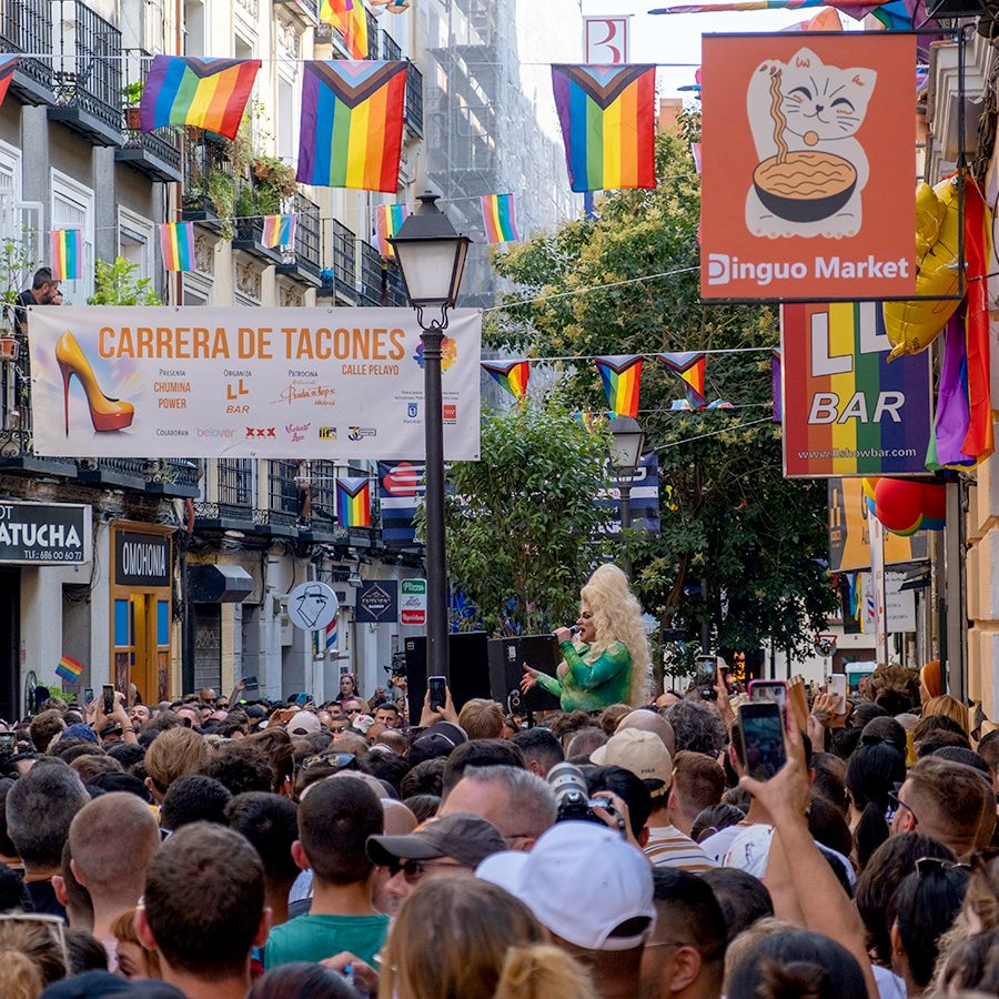 A crowd in celebrating heels race or corrida de tacones at a pride parade in Madrid, Spain
