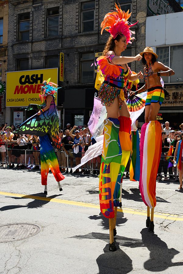 Performers on stilts at a Pride Parade in Toronto, Canada