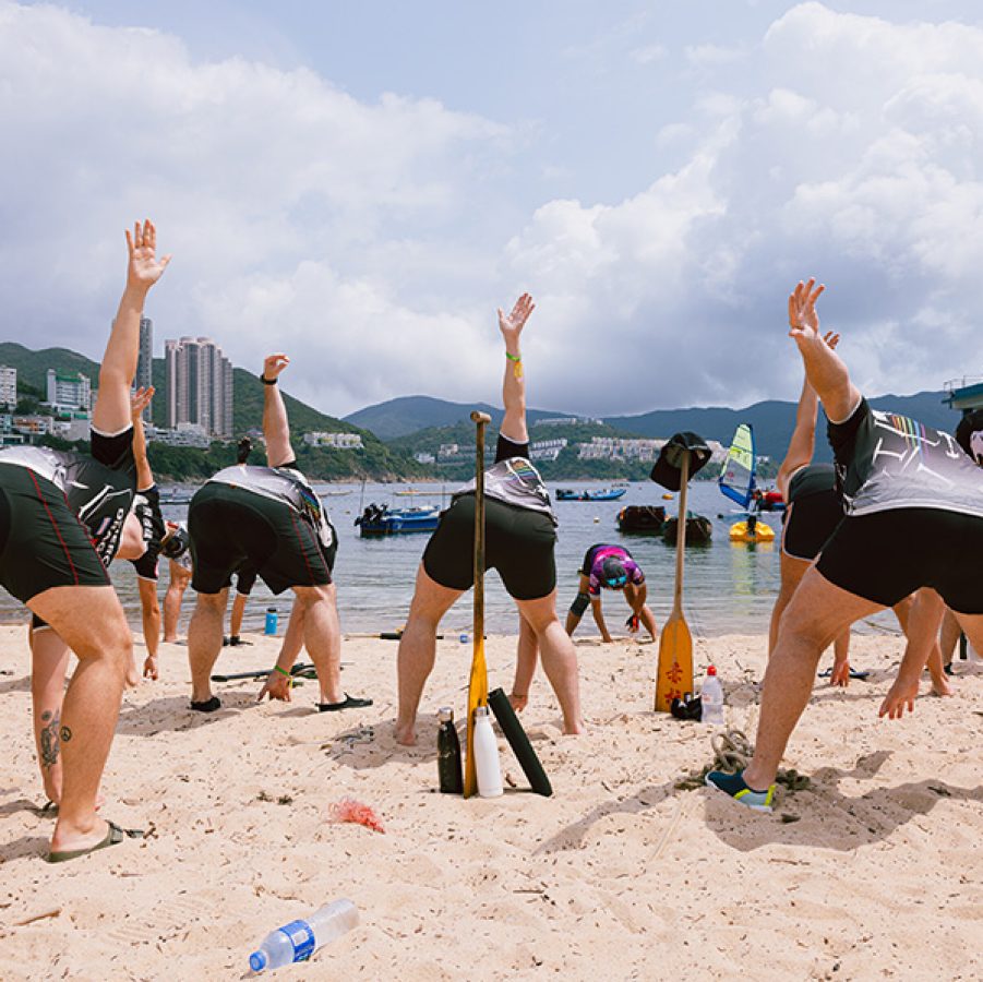 The Fierce Dragons stretching on Stanley Beach