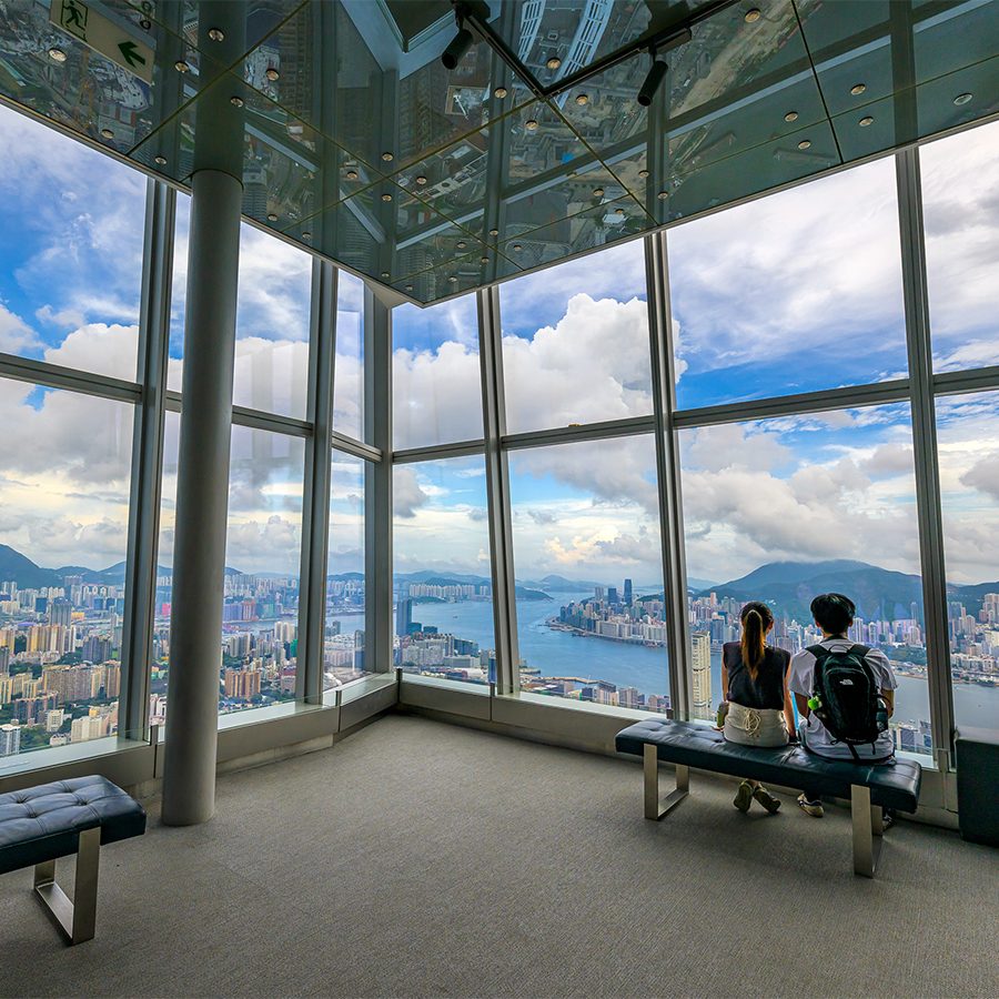 A couple sits on a bench at the northeast deck of Sky100 to enjoy the view.