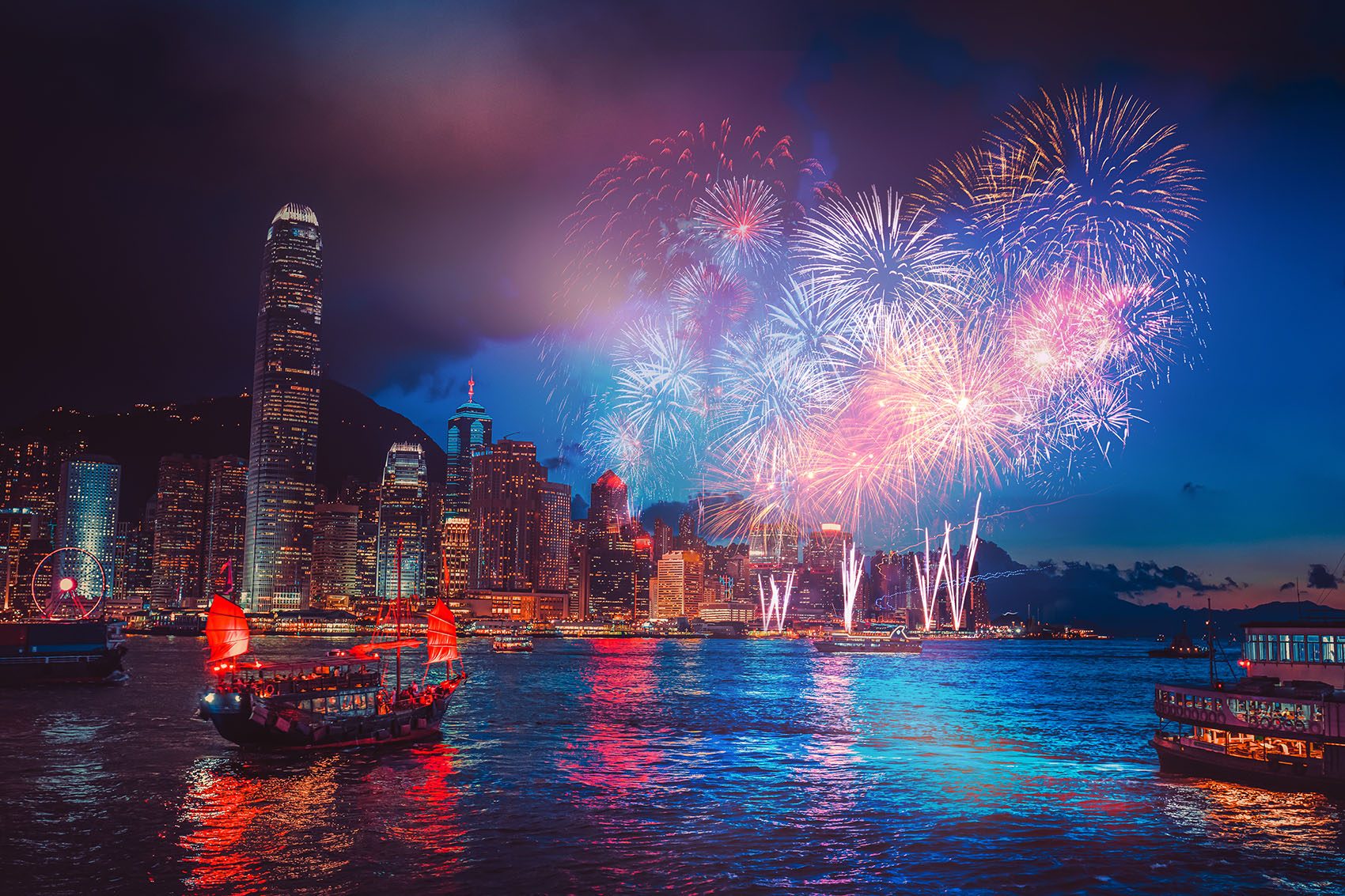 A photo of a firework show happening at Victoria Harbour, Hong Kong