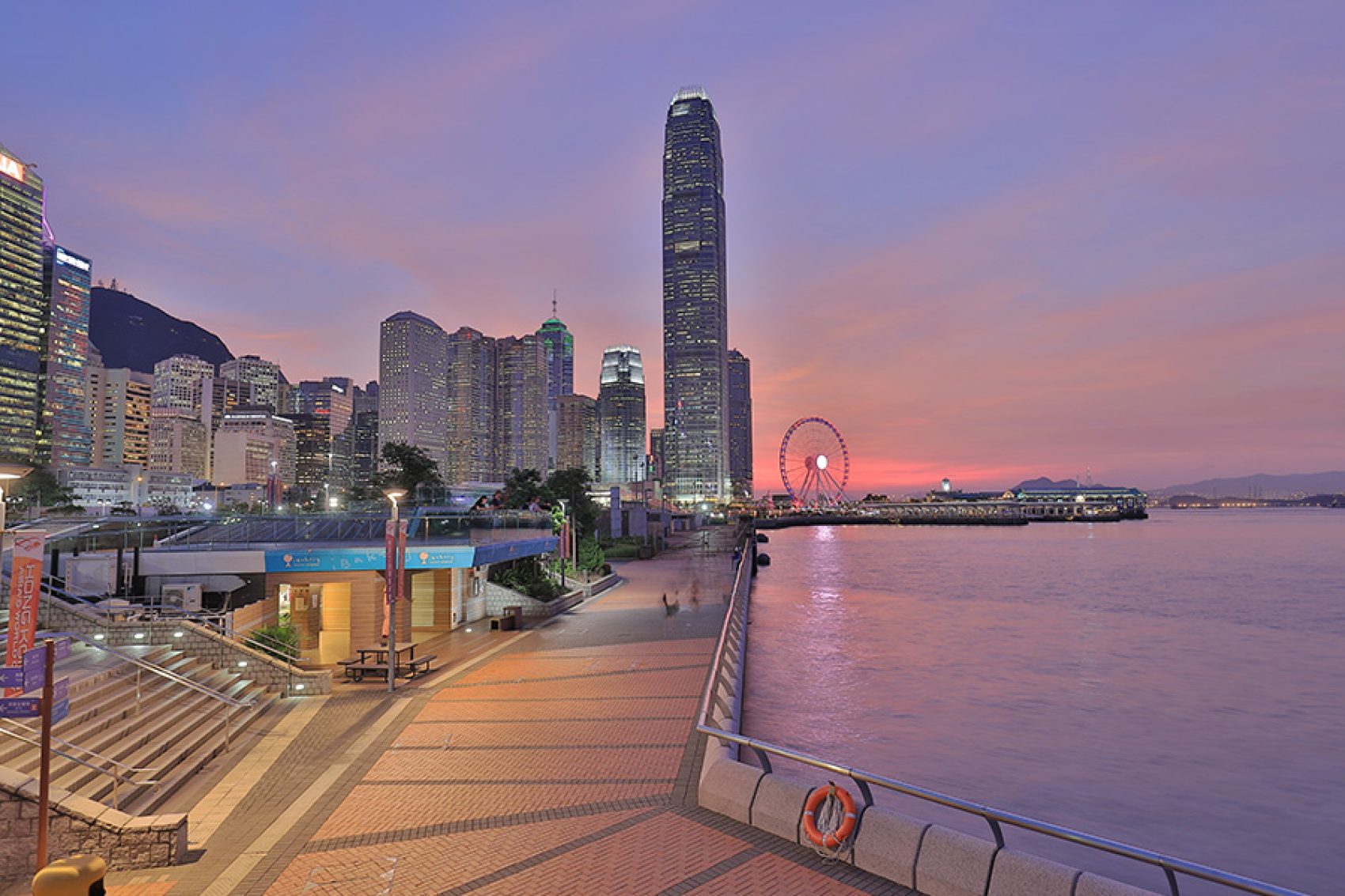 Tamar Park in Central under a purple evening sky.