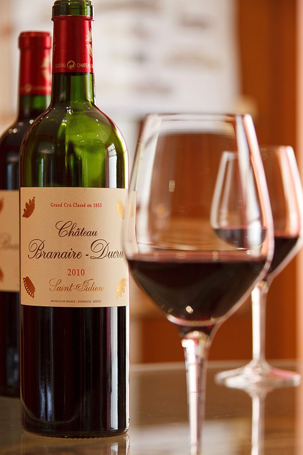 Two bottles of red wine and two glasses of red wine