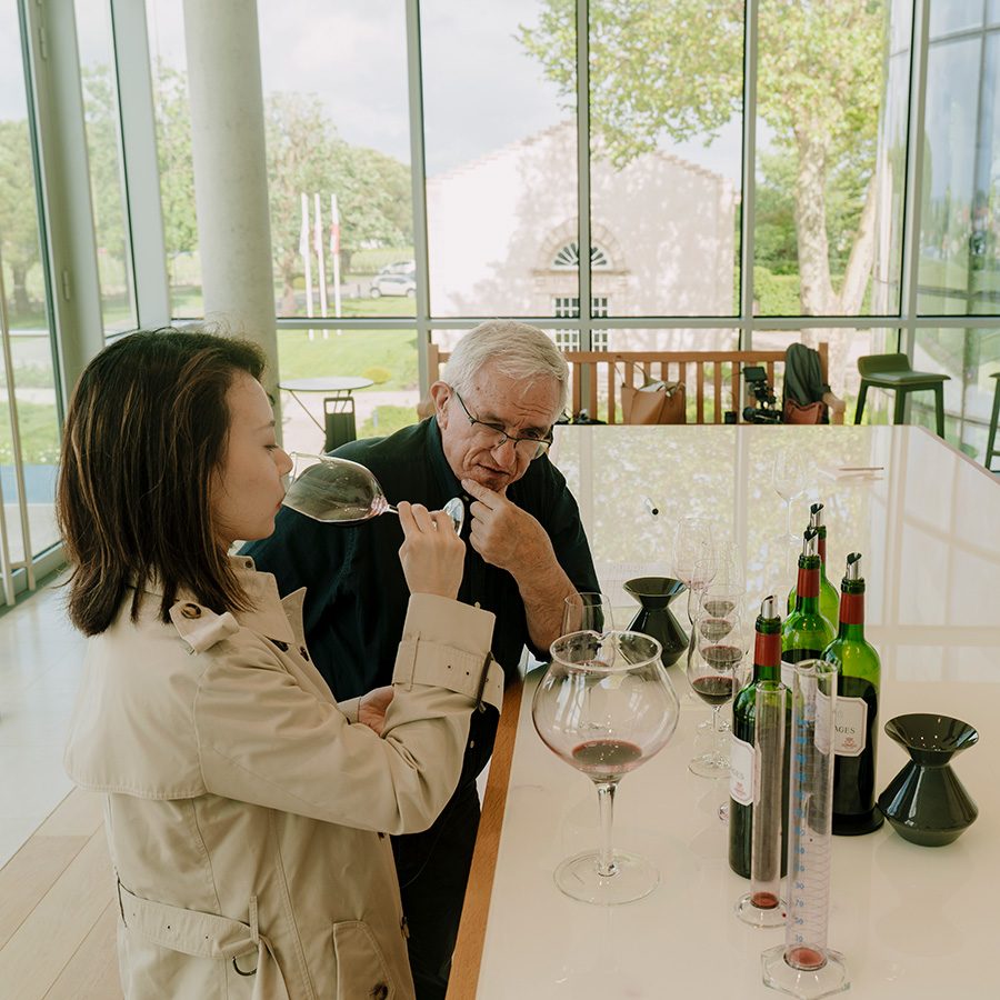 A man and a lady are tasting wine
