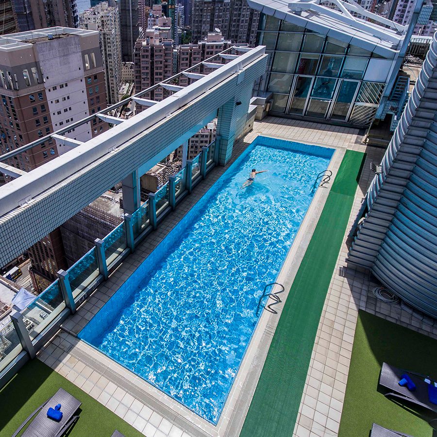 People swimming at JEN Hong Kong by Shangri La's swimming pool