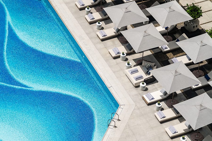 A pool at Regent Hong Kong with a lounge area
