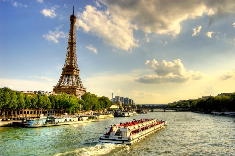 A wide angle shot of the Eiffel Towel and the Quay Seine River during the day