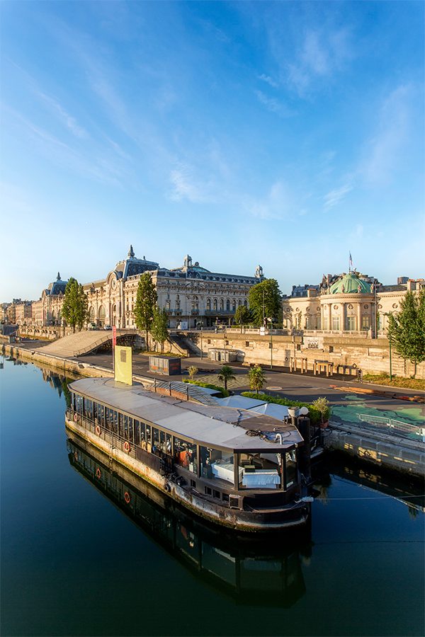 A photo of a boat tour cruising along Musée d'Orsay in Paris, France during the day