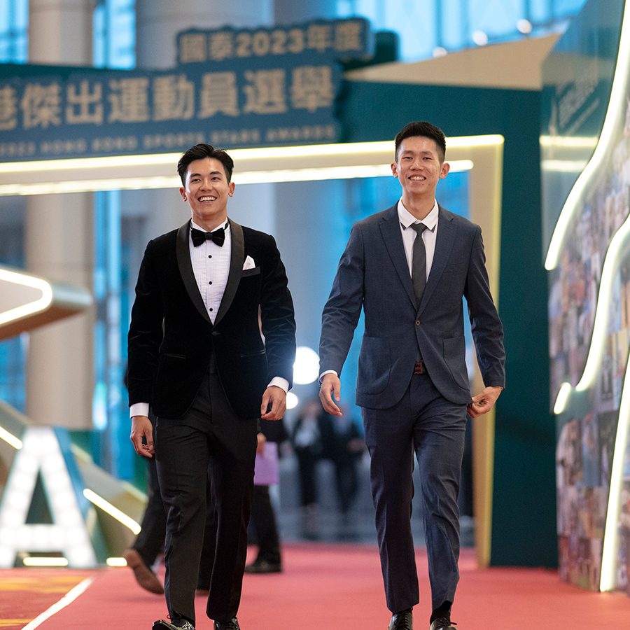 A pair of male Rowing athletes are walking down the red carpet.
