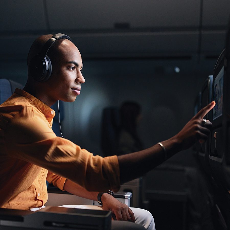 Man touching screen with headphones