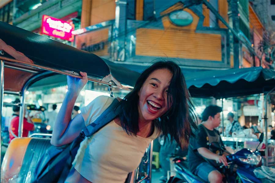 Woman laughing in Bangkok during night