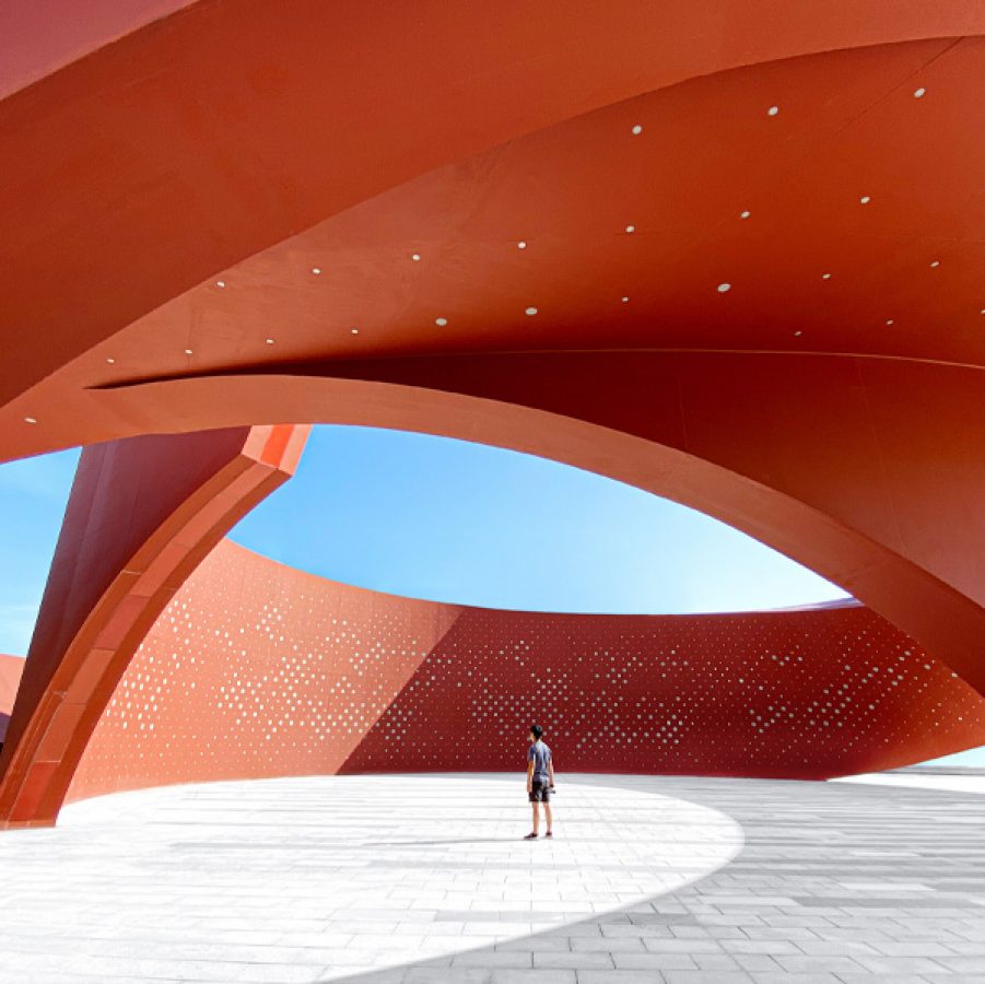Person standing under cultural landmark