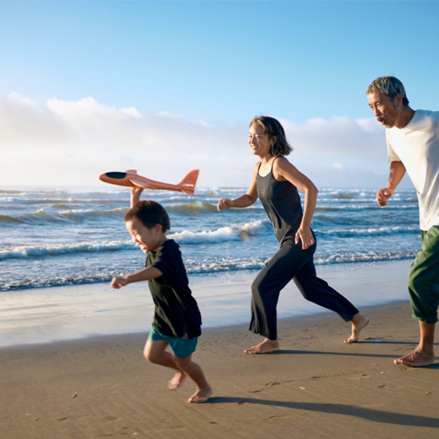 Family running on beach