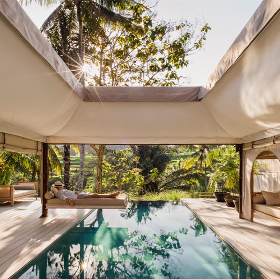 A man sleeping by a luxurious pool