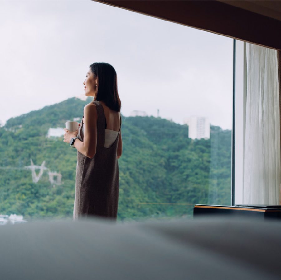 Woman standing in window of hotel