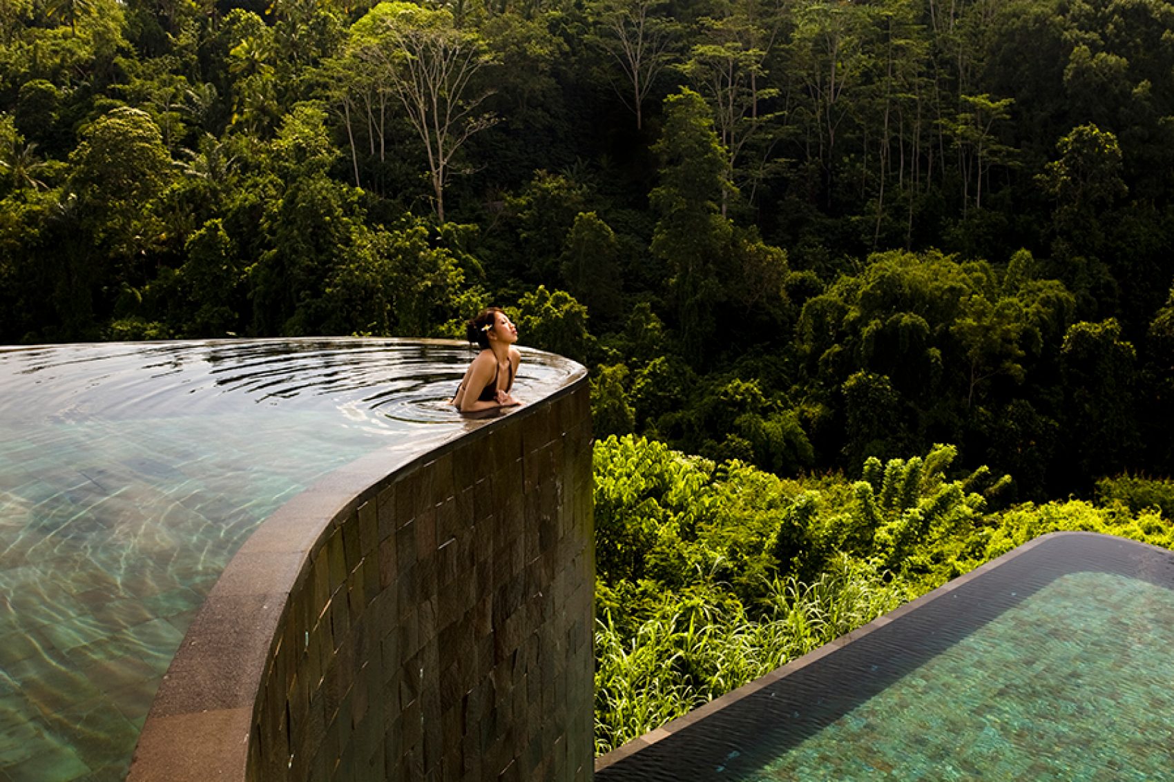 Woman enjoying in a pool in Bali, Indonesia 