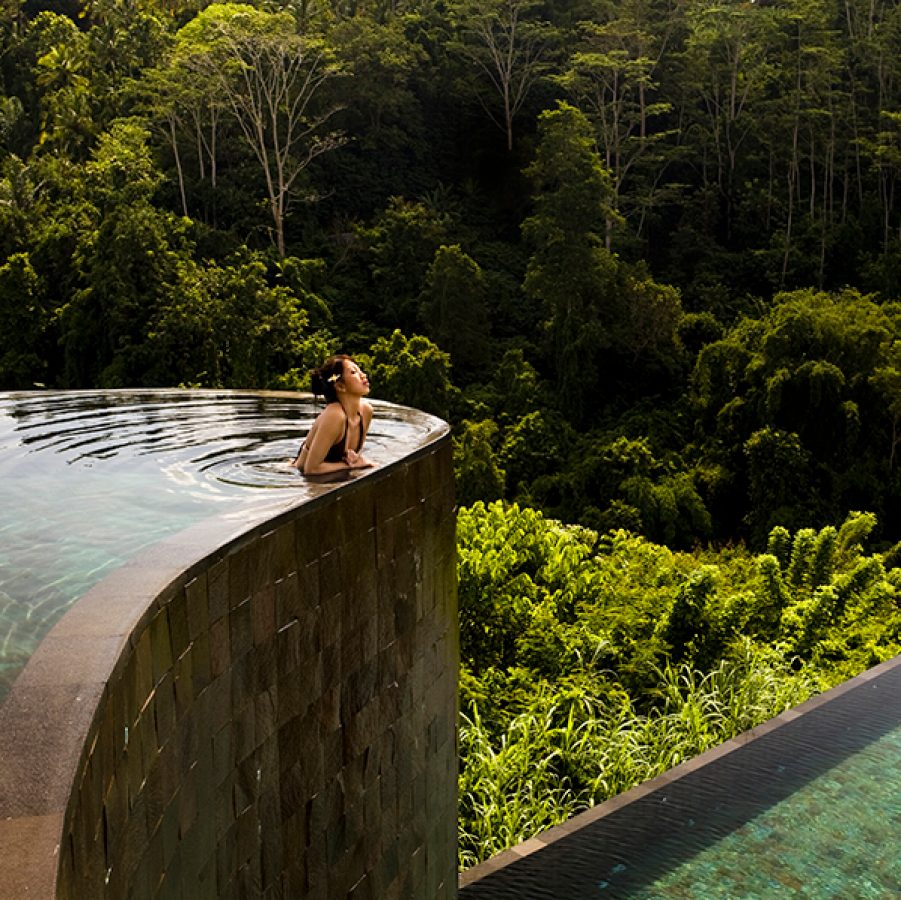 Woman enjoying in a pool in Bali, Indonesia 