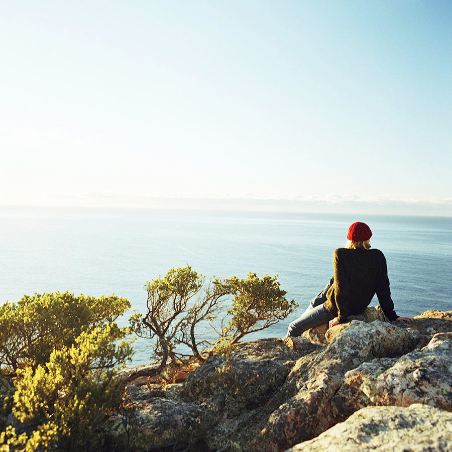Man sitting on a rock in Tasmania, Australia 