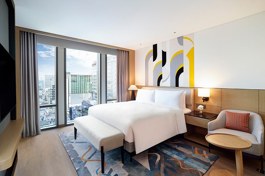 An image of the bedroom interior at Le Méridien Seoul, Myeongdong hotel with daylight coming through the windows
