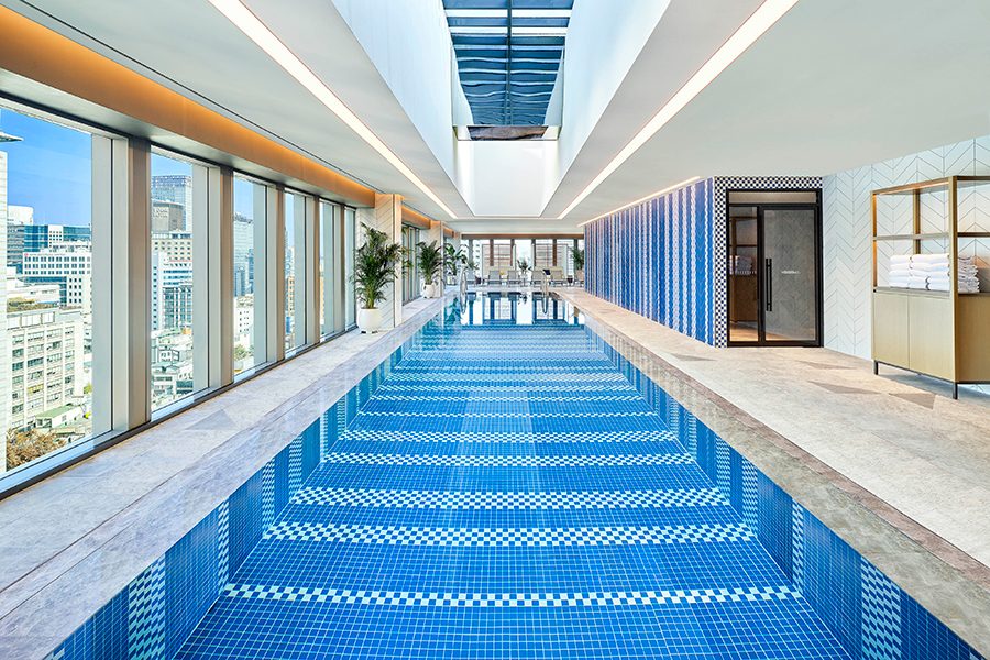 An image of the indoor pool with city views at Le Méridien Seoul, Myeongdong hotel with daylight through coming the windows and skylight
