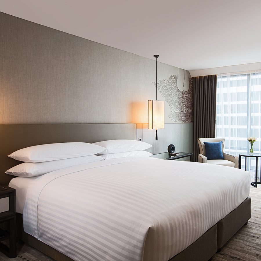 A view of the bedroom interior of Marriott Marquis Queen’s Park hotel at night in Bangkok, Thailand