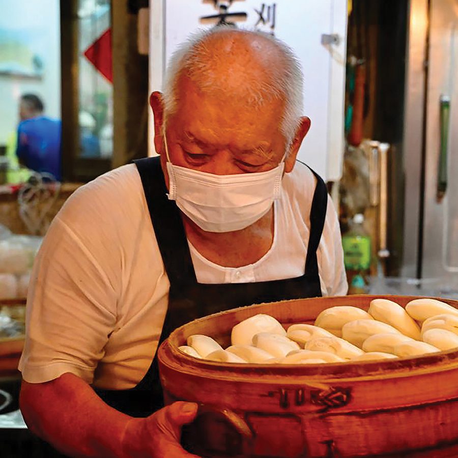 Old man holding Gua Bao