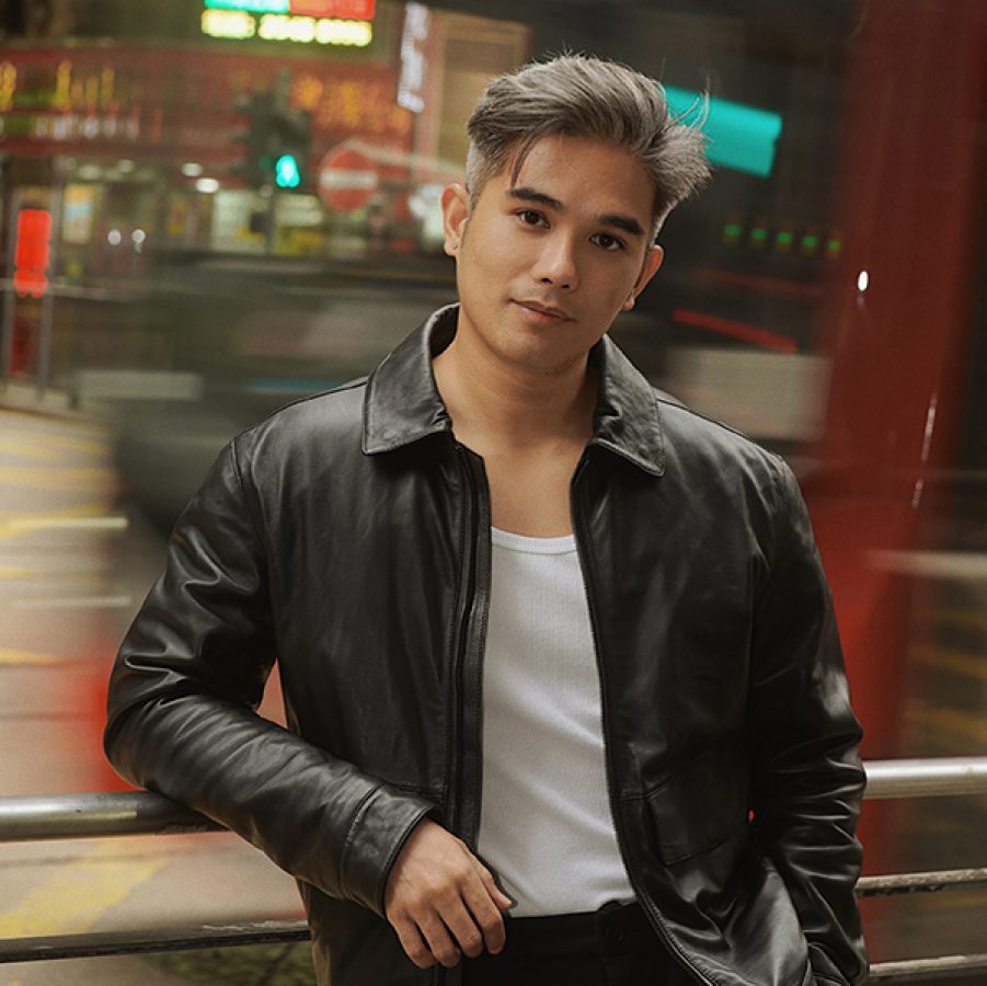 Portrait of a man standing in the street.