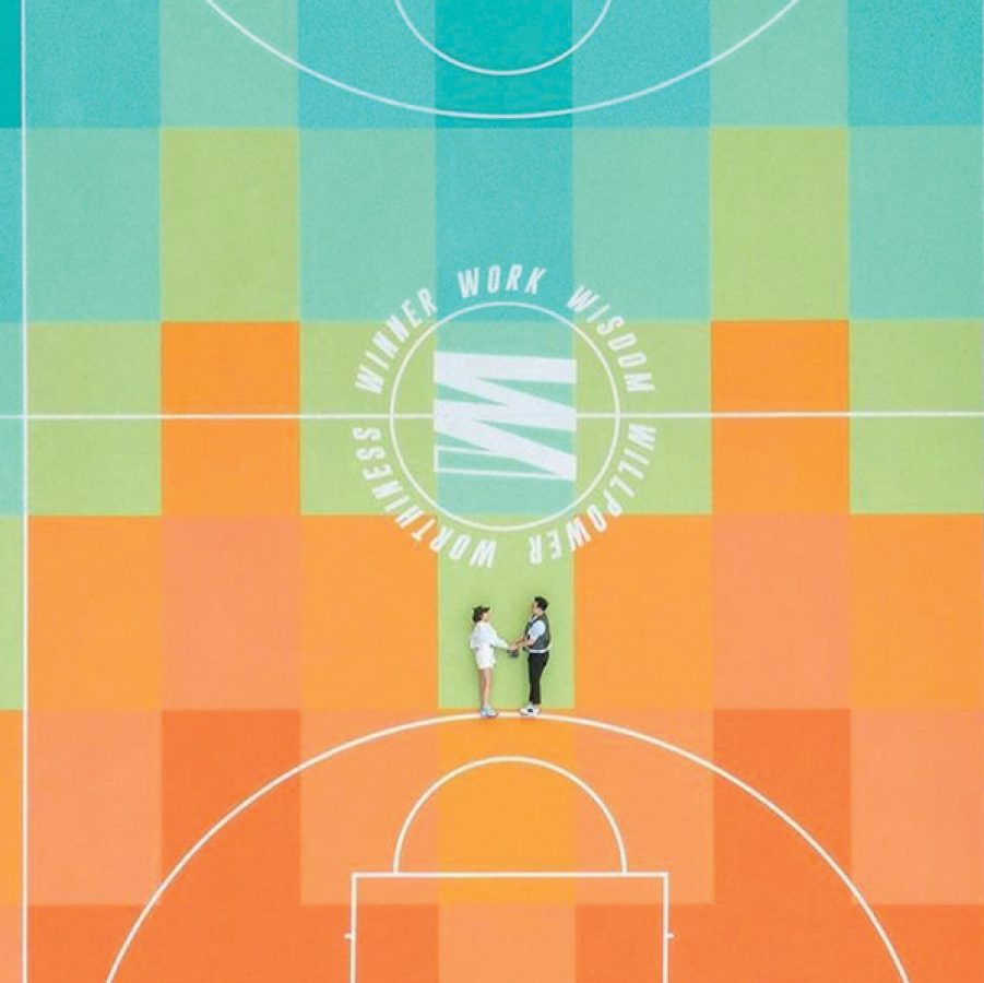 Aerial photo of a couple lying on a colorful basketball court