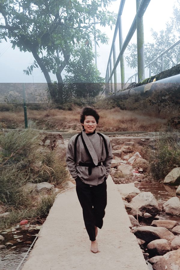 A woman is standing in the middle of the road.
