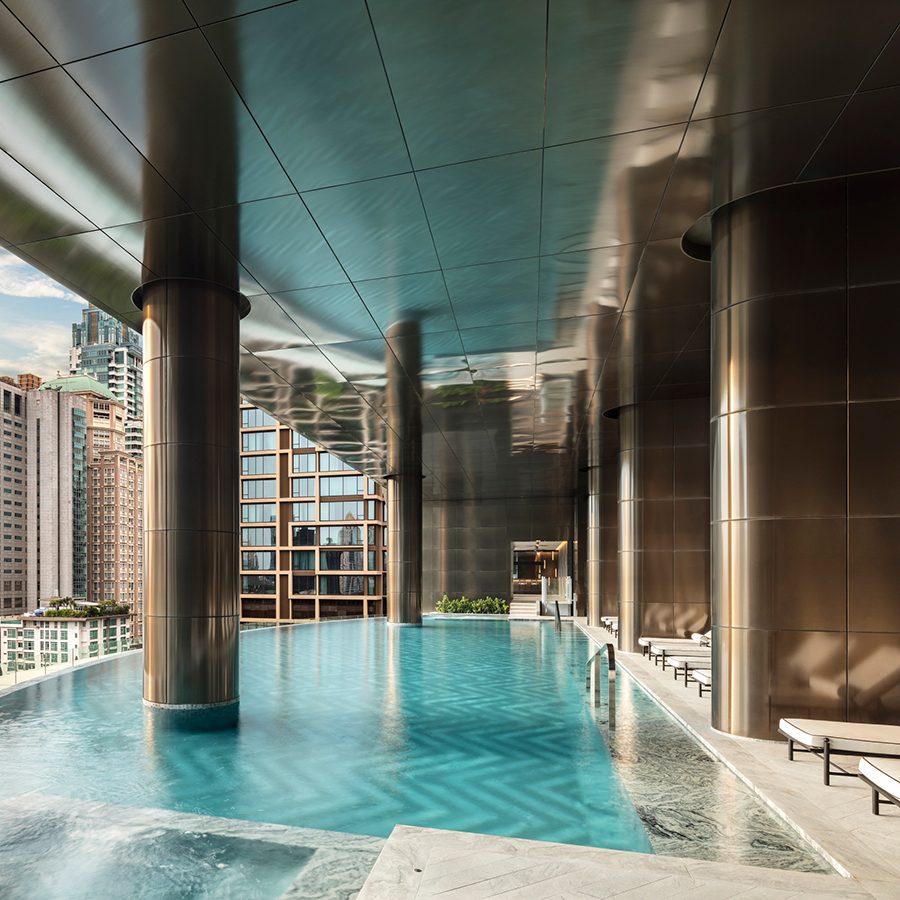 The open space swimming pool with a city view inside Sindhorn Kempinski Hotel Bangkok, Thailand