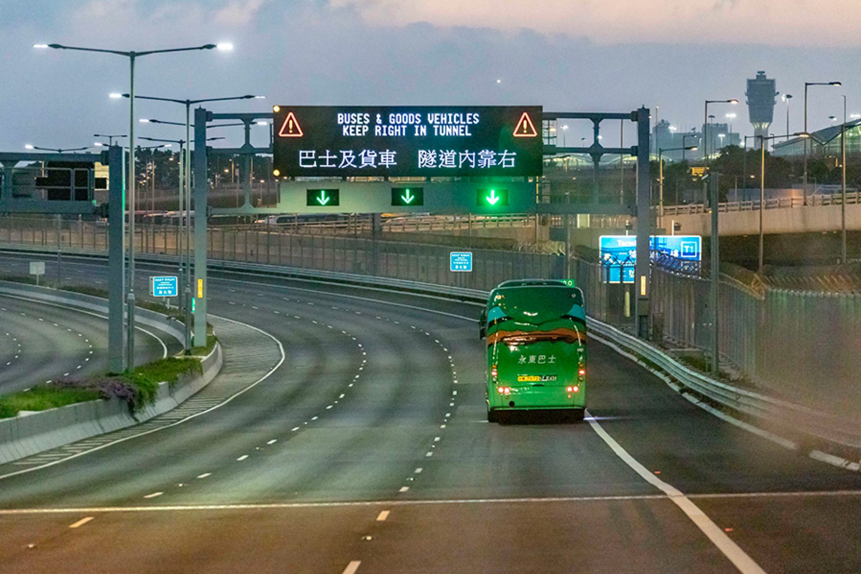 On the highway at night with some shuttle bus travelling.