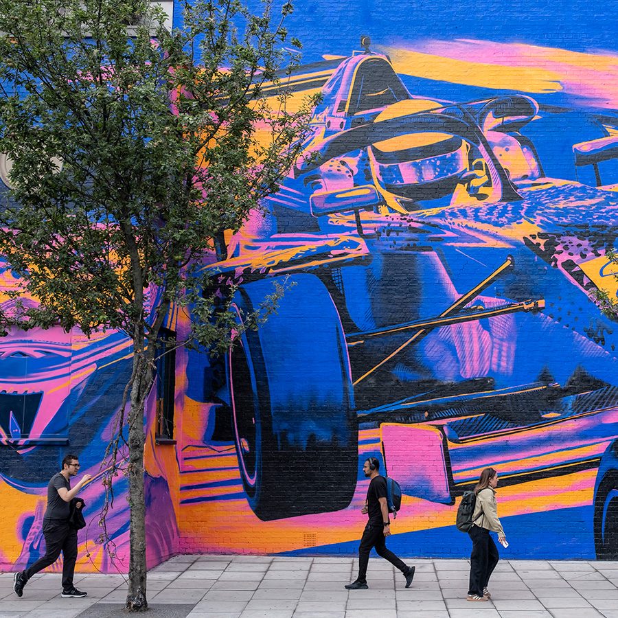 A photo of street art in London and people walking on the street