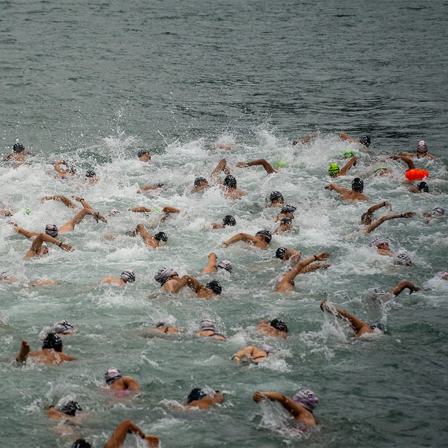 People having a swimming race in the harbour in Hong Kong