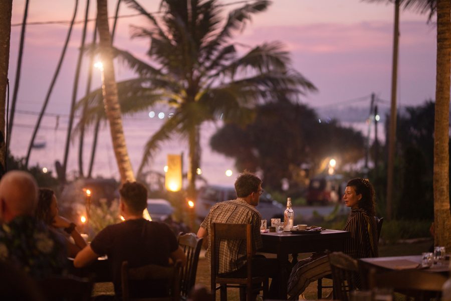 People dining outdoors at Smoke & Bitters in Hiriketiya, Sri Lanka