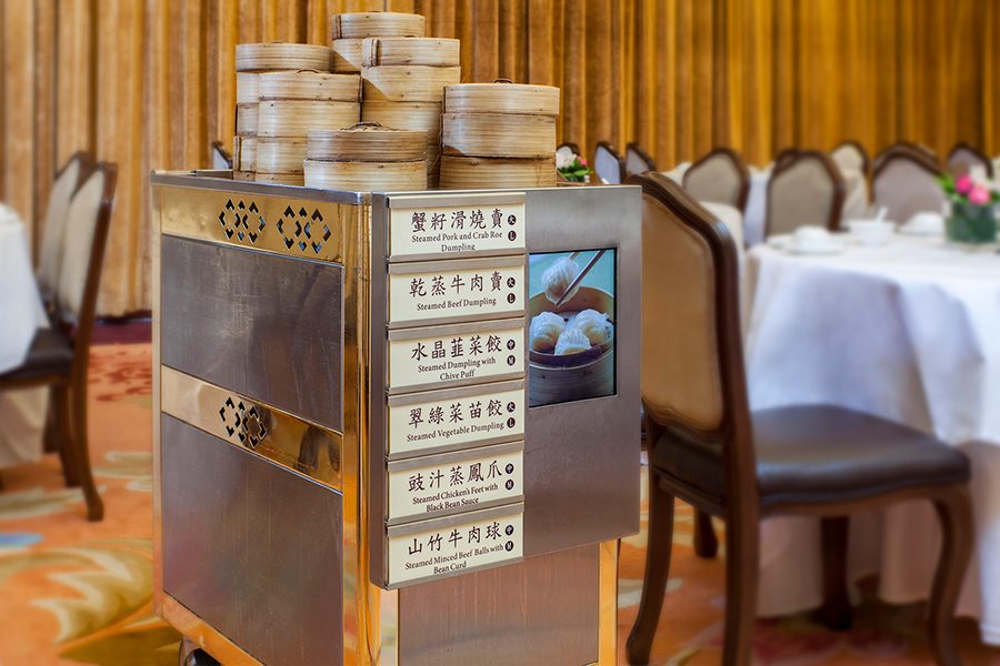 A trolley loaded with bamboo steamer baskets at an elegant restaurant 