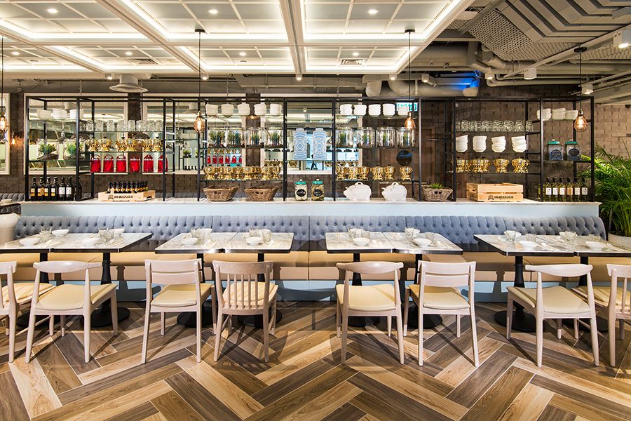 A row of dining tables in a brightly lit restaurant