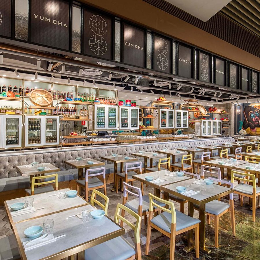 An open-plan restaurant filled with rows of tables and chairs 
