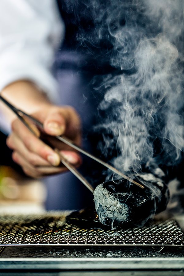 A chef on the grill at Ensue, a Western fine dining restaurant in Shenzhen