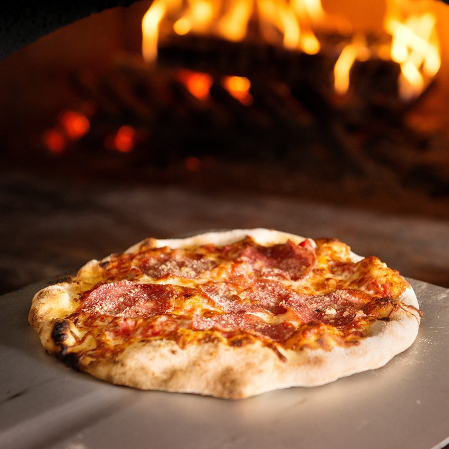 A wood fired made pizza at Caramba Restaurant