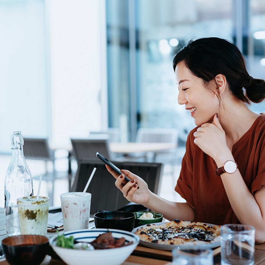 Asian woman checking social media