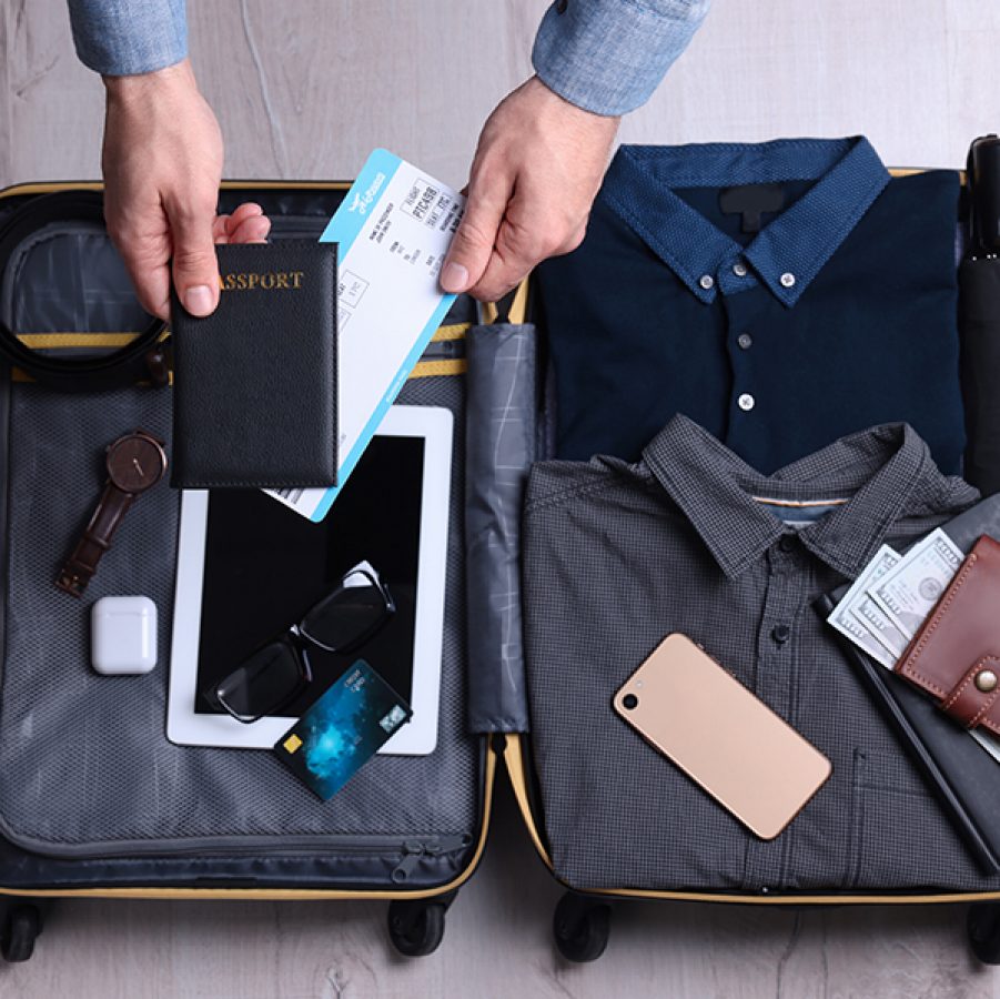 Man packing suitcase for business trip