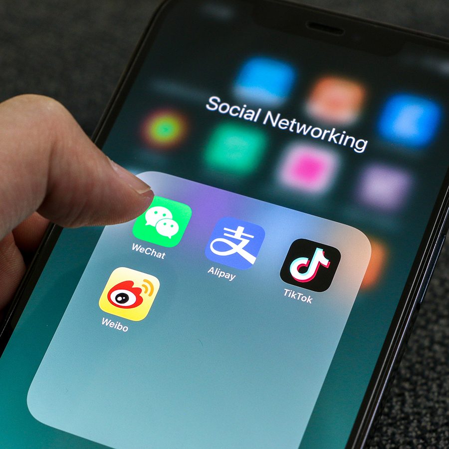 A close up of someone tapping into WeChat app on a mobile device