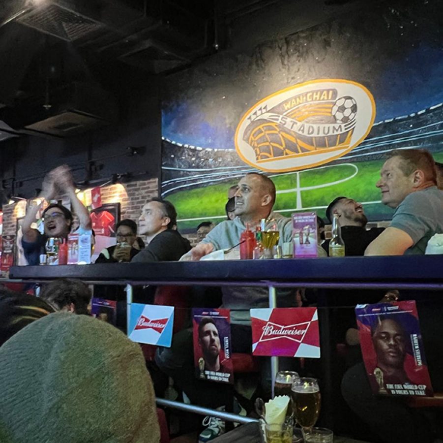 People watching games and drinking in Wan Chai Stadium.