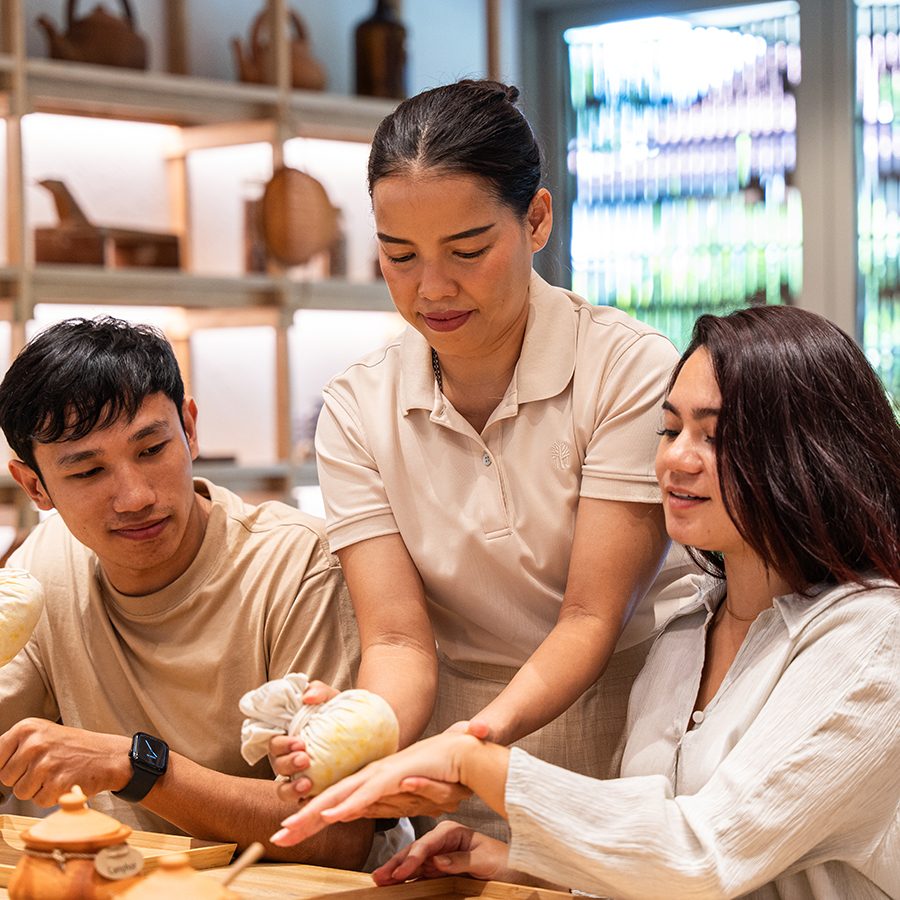 An instructor teaching a couple how to make DIY body scrubs at Nature House workshop at Banyan Tree Phuket, Thailand