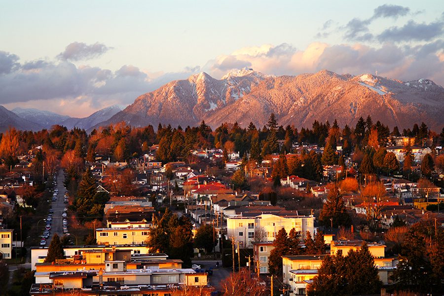 An aerial view of mountains and buildings in Vancouver city
