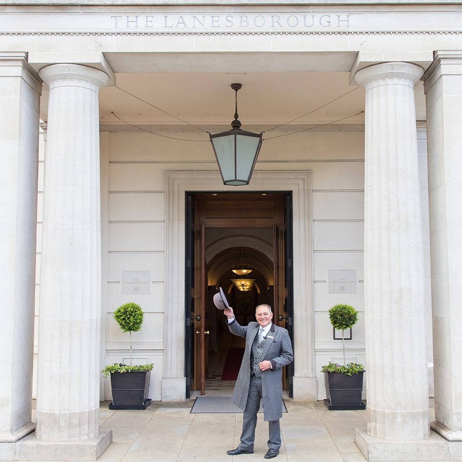 A butler welcomes guests at the entrance to The Lanesborough London.