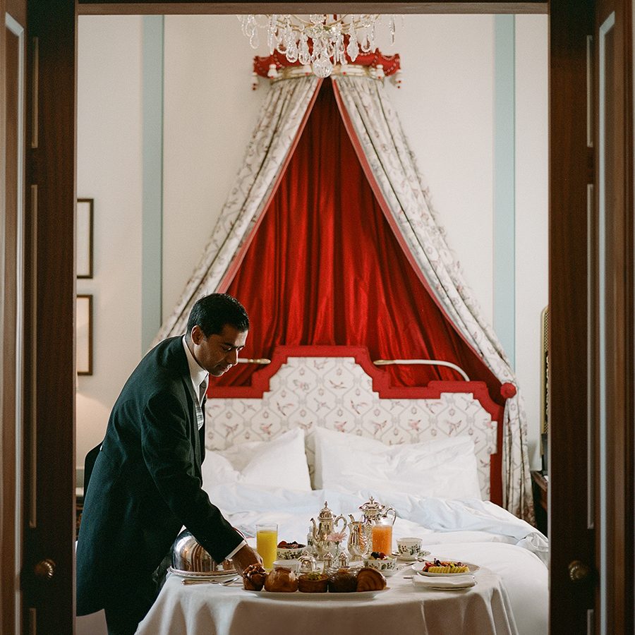 A housekeeper serves drinks at The Lanesborough London suite.