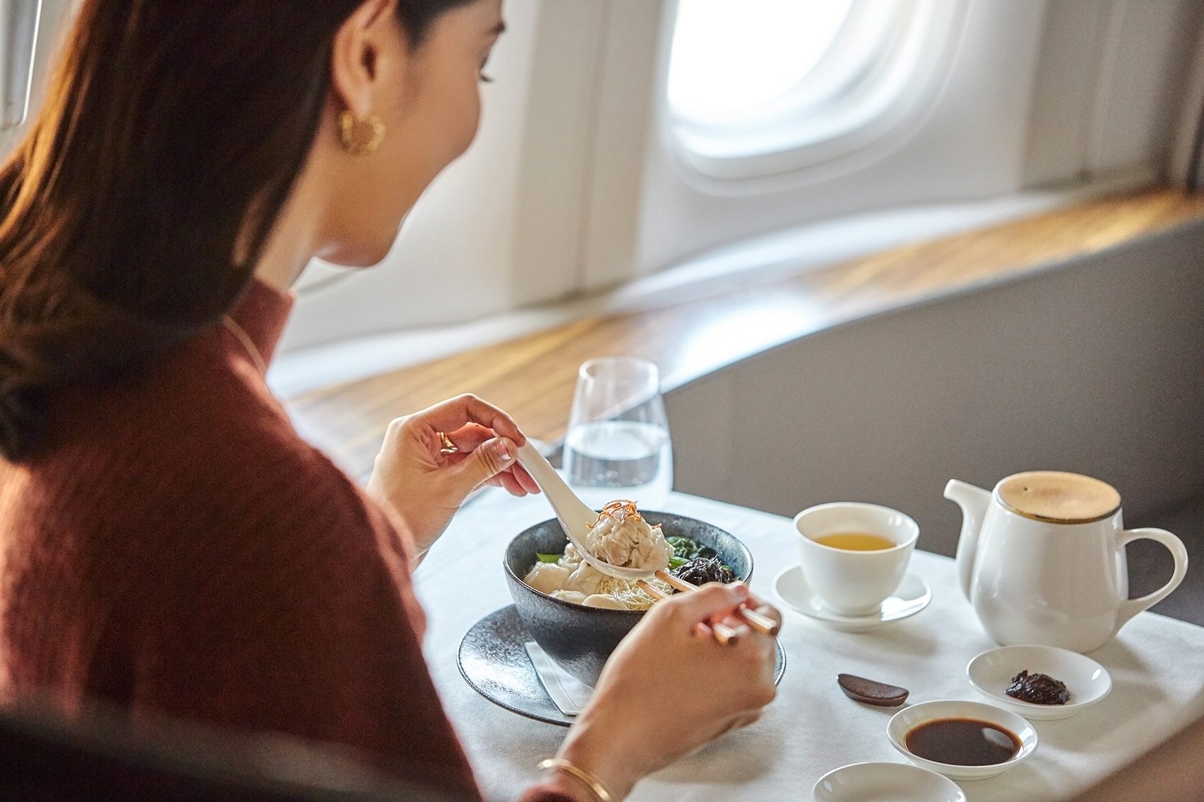 Woman eating in-flight meal
