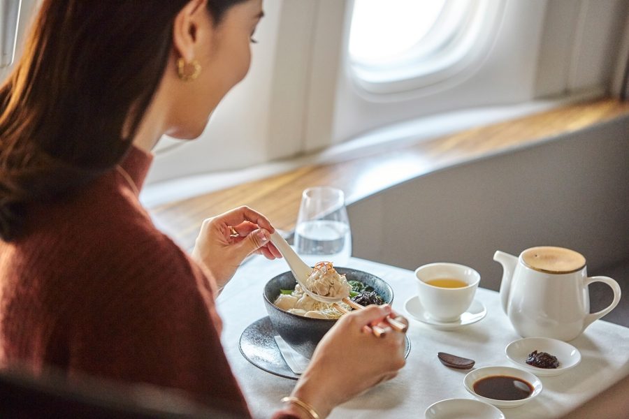 Woman eating in-flight meal