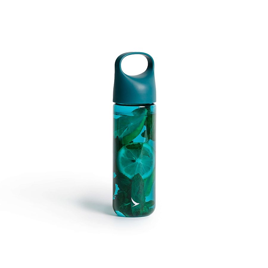 A Cathay water bottle in signature Jade green filled with lemon and leaves